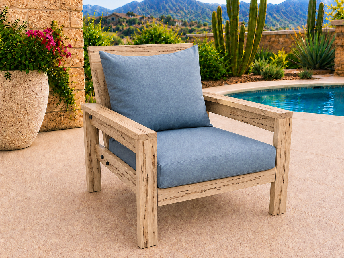Classic Chair in Ambrosia Maple with Matte Clear finish and blue cushions on a desert patio.