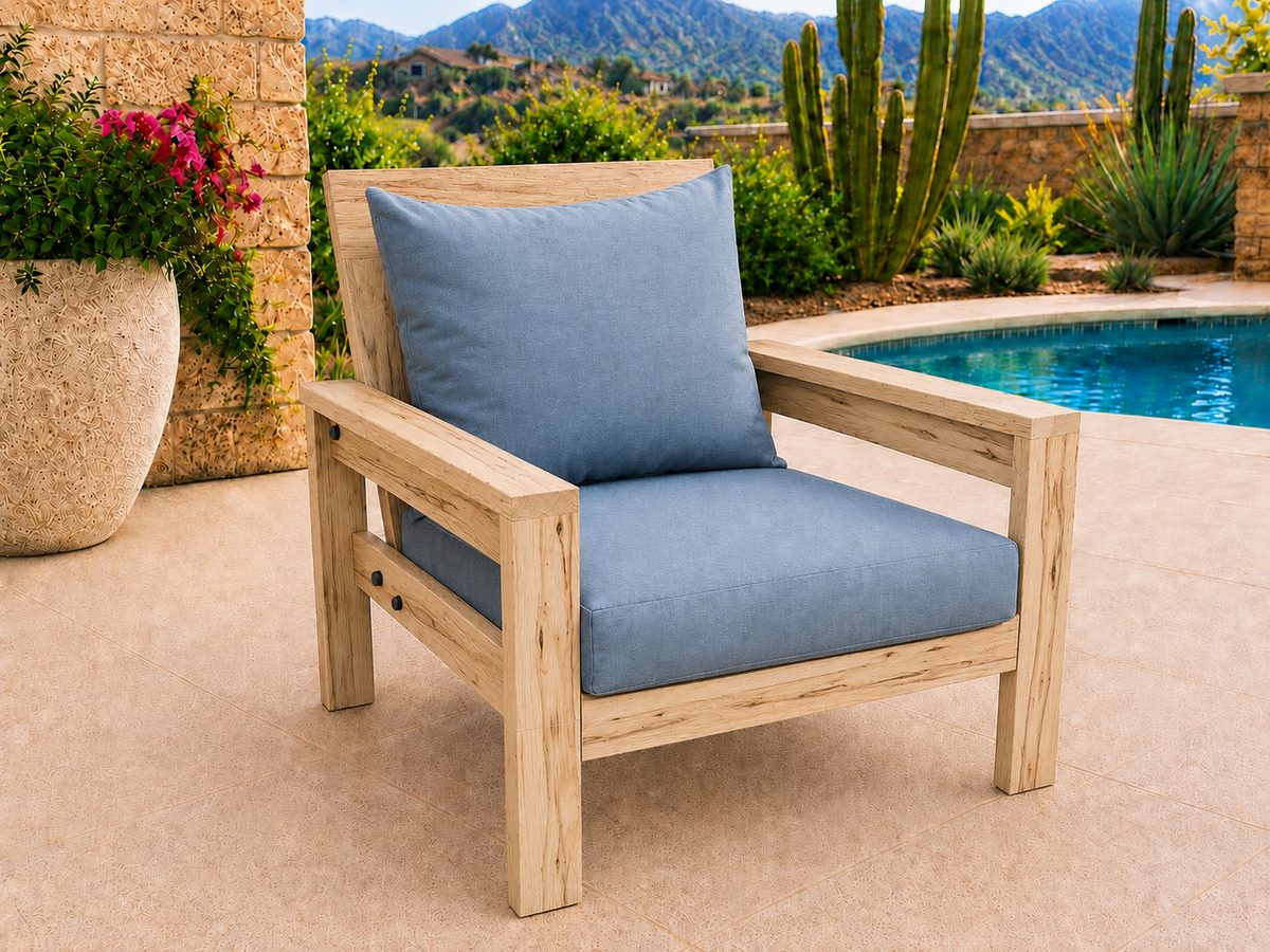 Classic Chair in Ambrosia Maple with Natural Satin finish and blue cushions on a desert patio.
