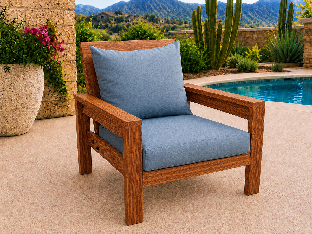 Classic Chair in Sapele Ribbon with Natural Satin finish and blue cushions on a desert patio.