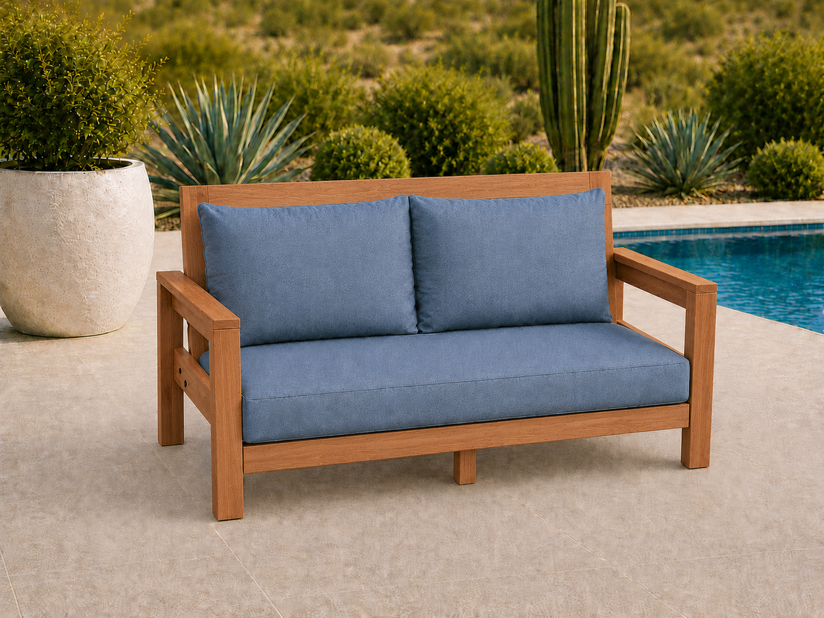 Classic Loveseat in Cherry with Natural Satin finish and blue cushions on a desert patio.