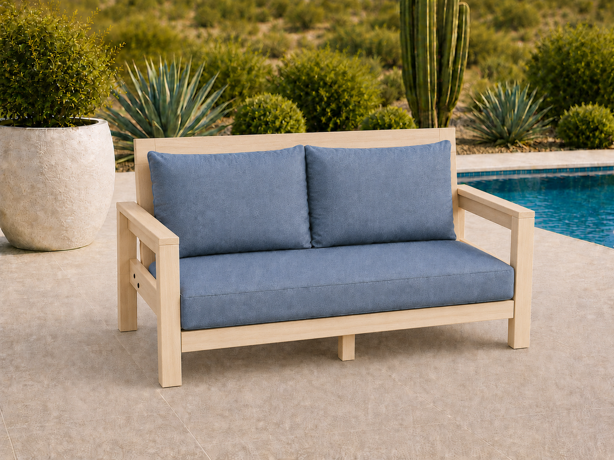 Classic Loveseat in Hard White Maple with Natural Satin finish and blue cushions on a desert patio.