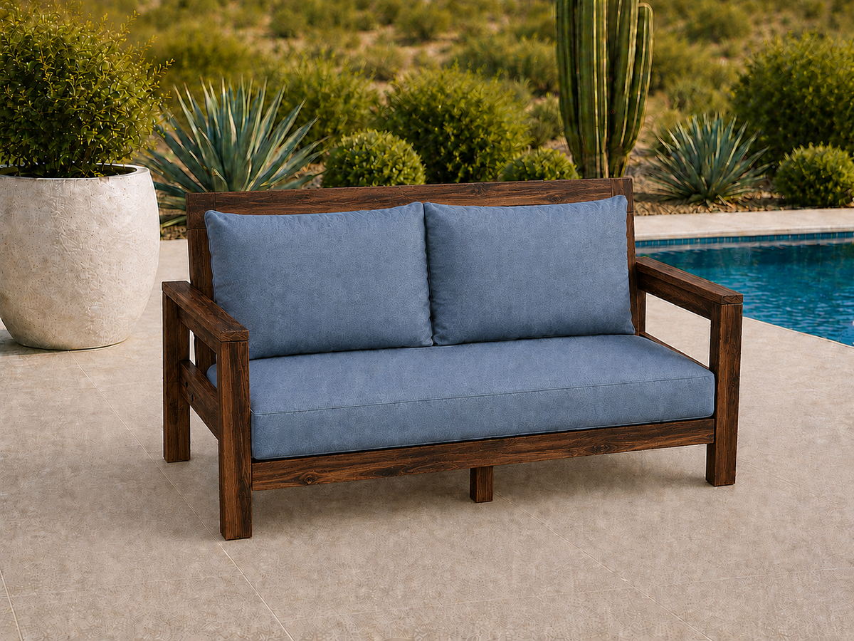 Classic Loveseat in Mesquite with Walnut Reserve finish and blue cushions on a desert patio.