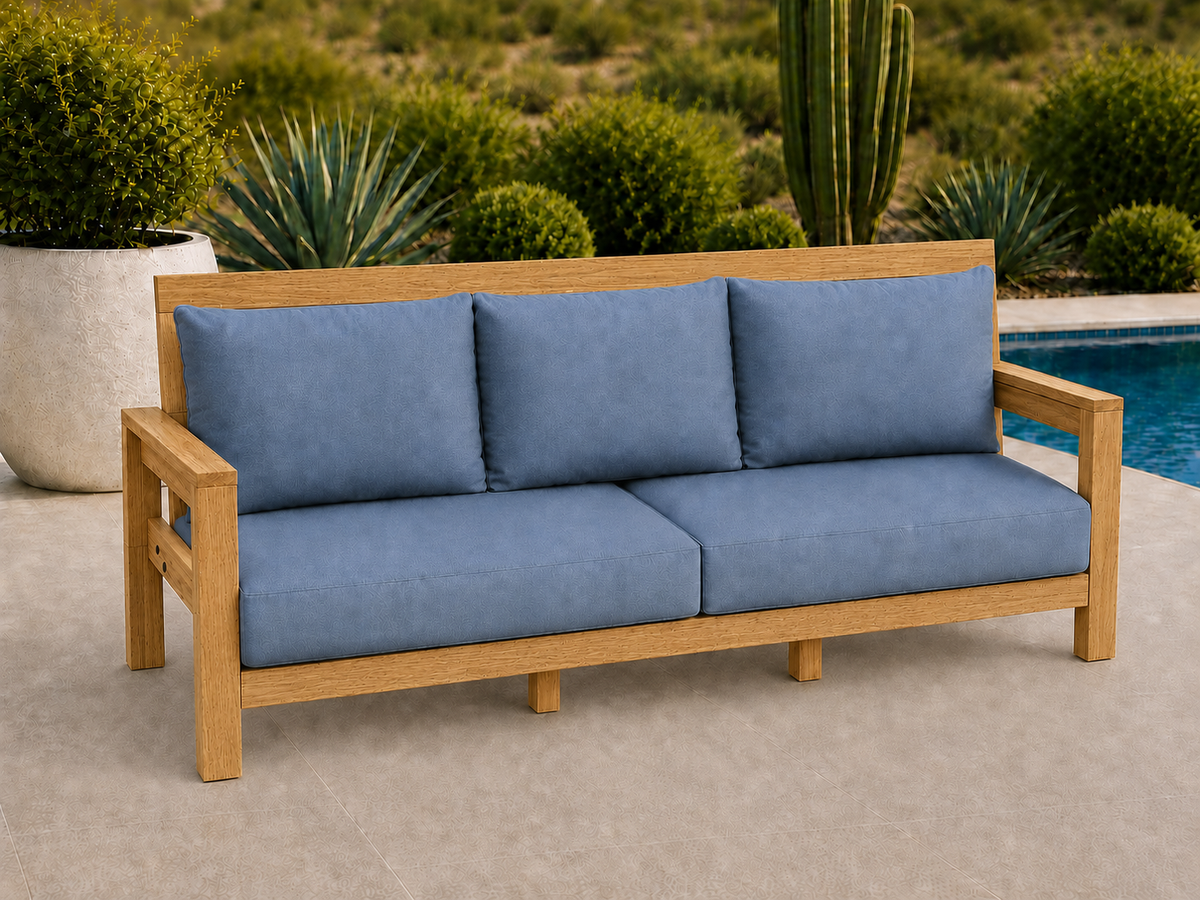 Classic Sofa in Canarywood with Natural Satin finish and blue cushions on a desert patio.