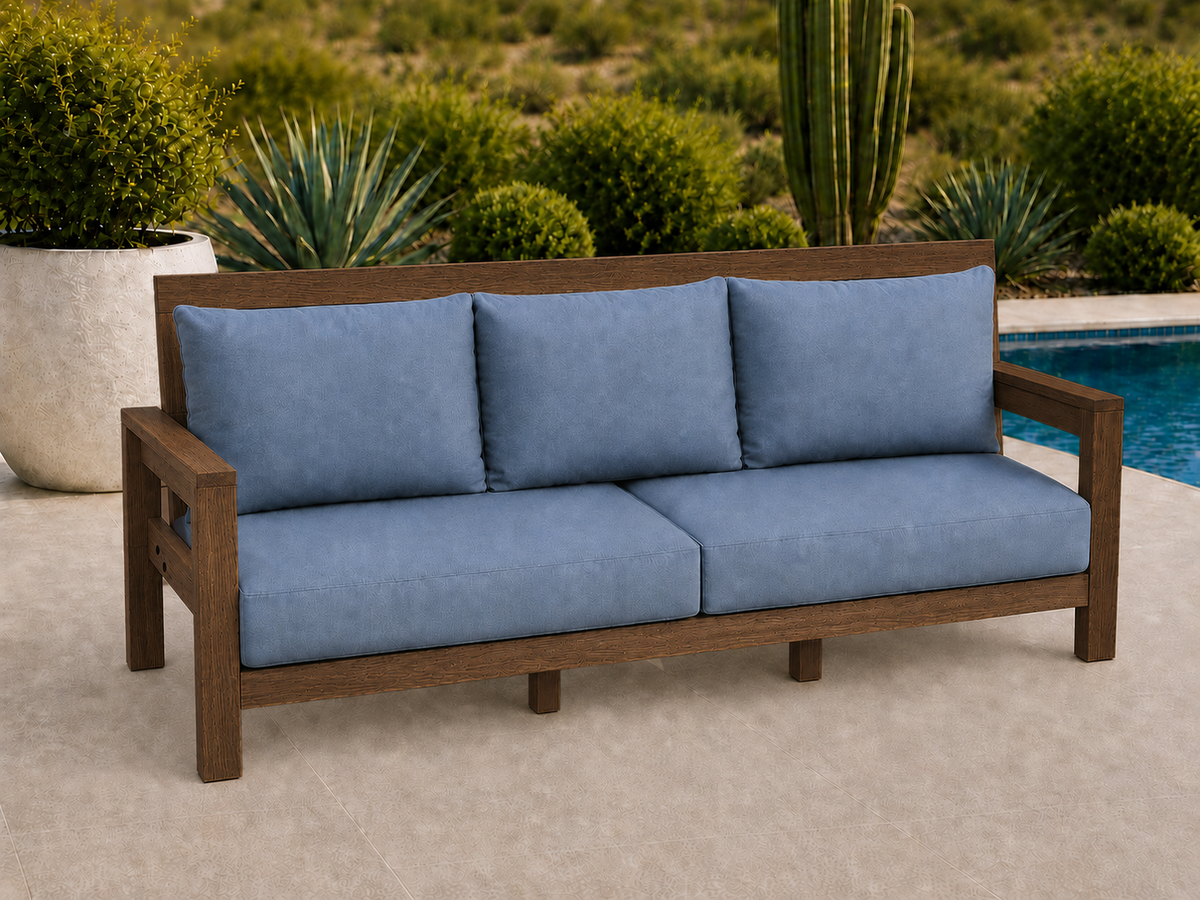 Classic Sofa in White Oak with Walnut Reserve finish and blue cushions on a desert patio.