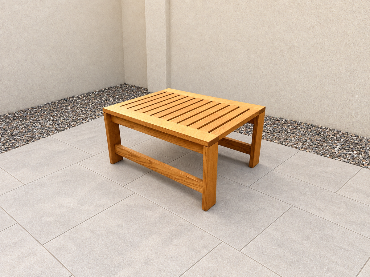 36-inch Classic Coffee Table in Red Oak with Canyon Honey finish, with an edited clean patio background.