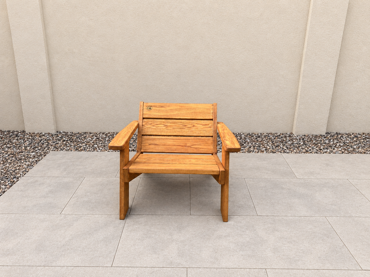 Front view of the Low Boy Adirondack Chair in Red Oak with Canyon Honey finish, with an edited clean patio background.