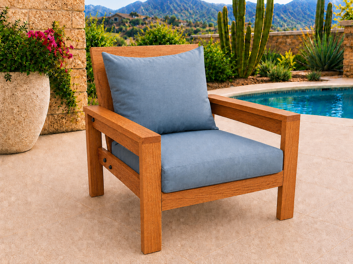 Classic Chair in African Mahogany with Light Honey finish and blue cushions on a desert patio.