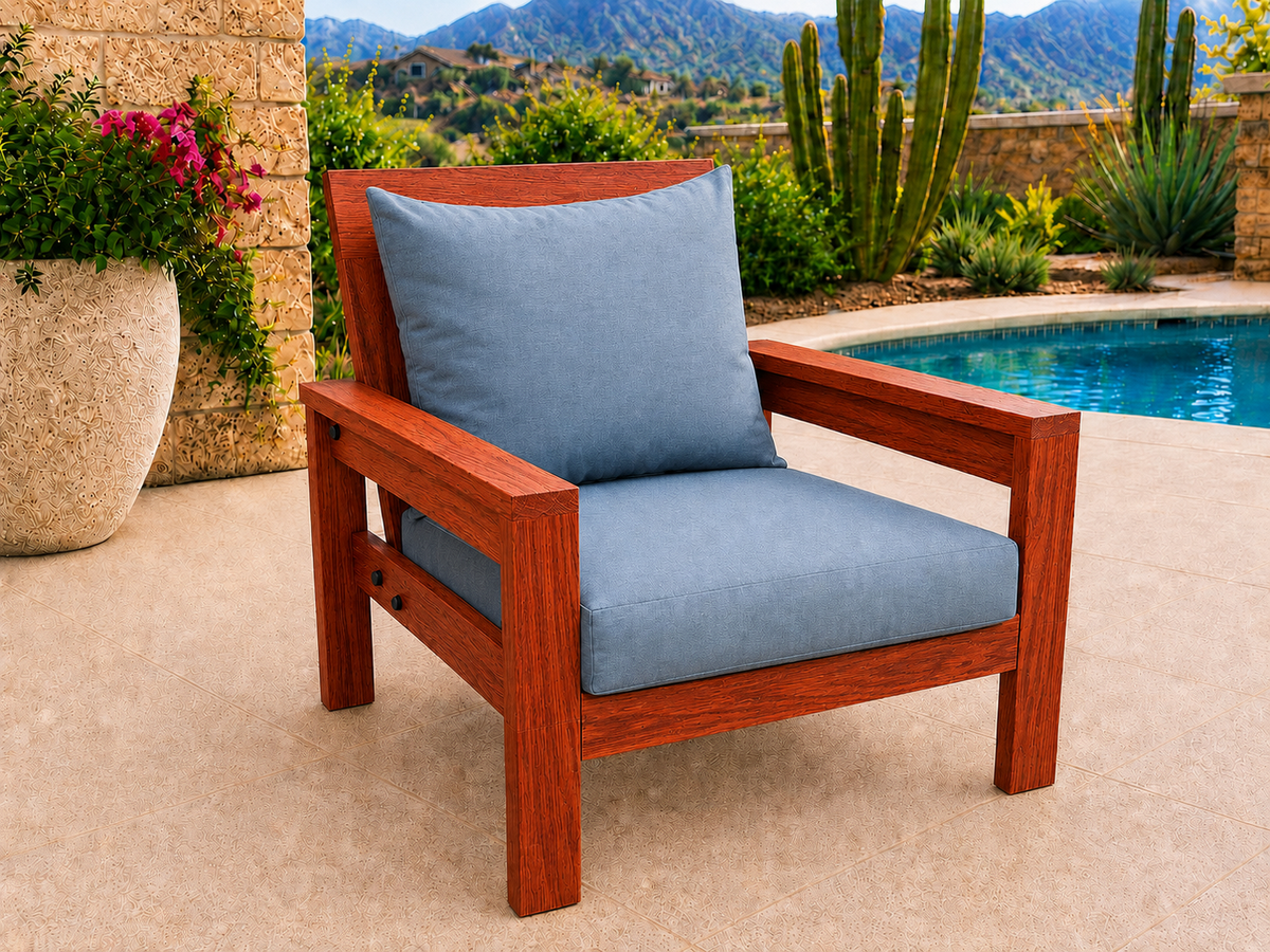Classic Chair in African Padauk with Satin Clear finish and blue cushions on a desert patio.