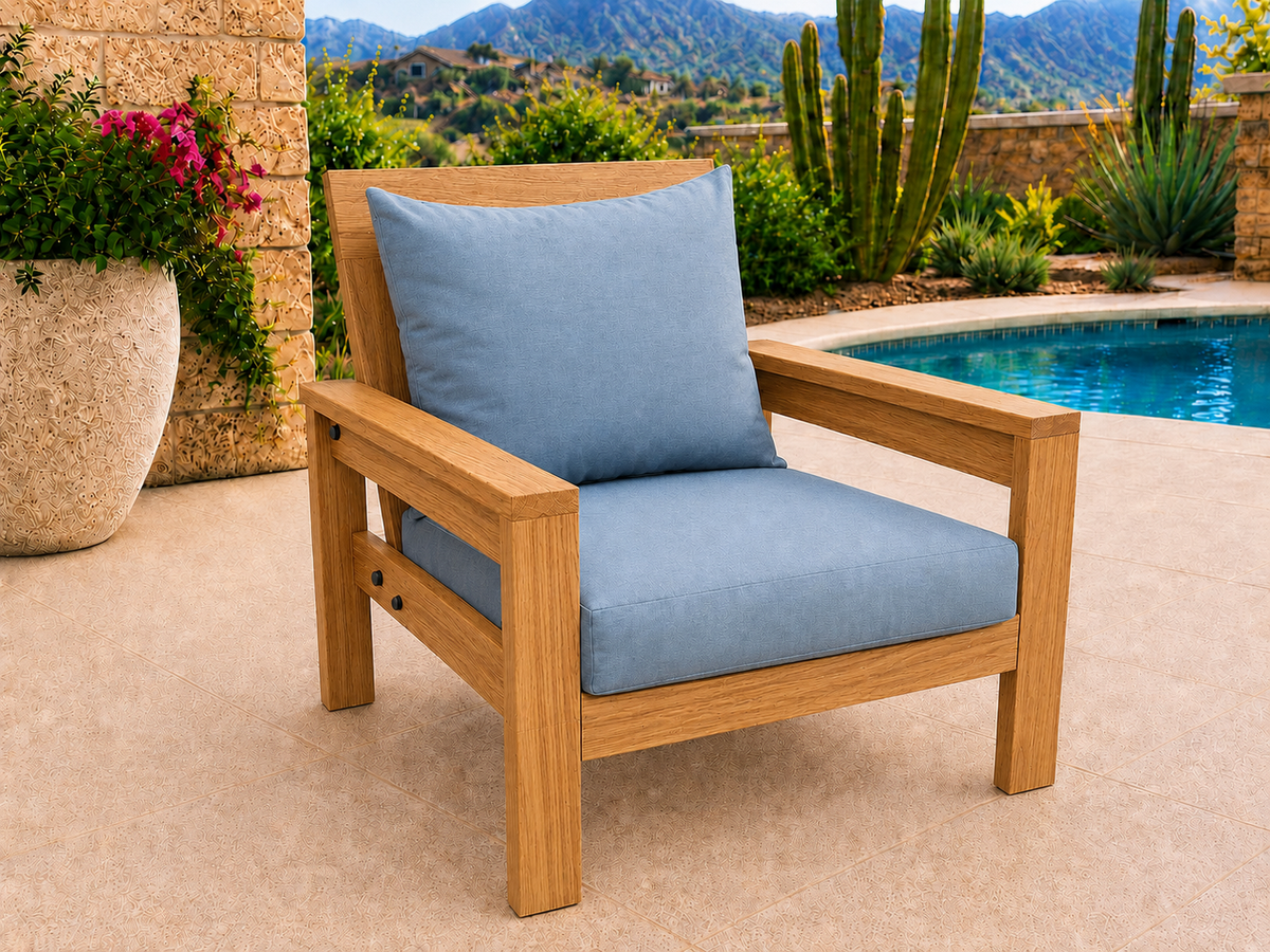 Classic Chair in Teak with Satin Clear finish and blue cushions on a desert patio.