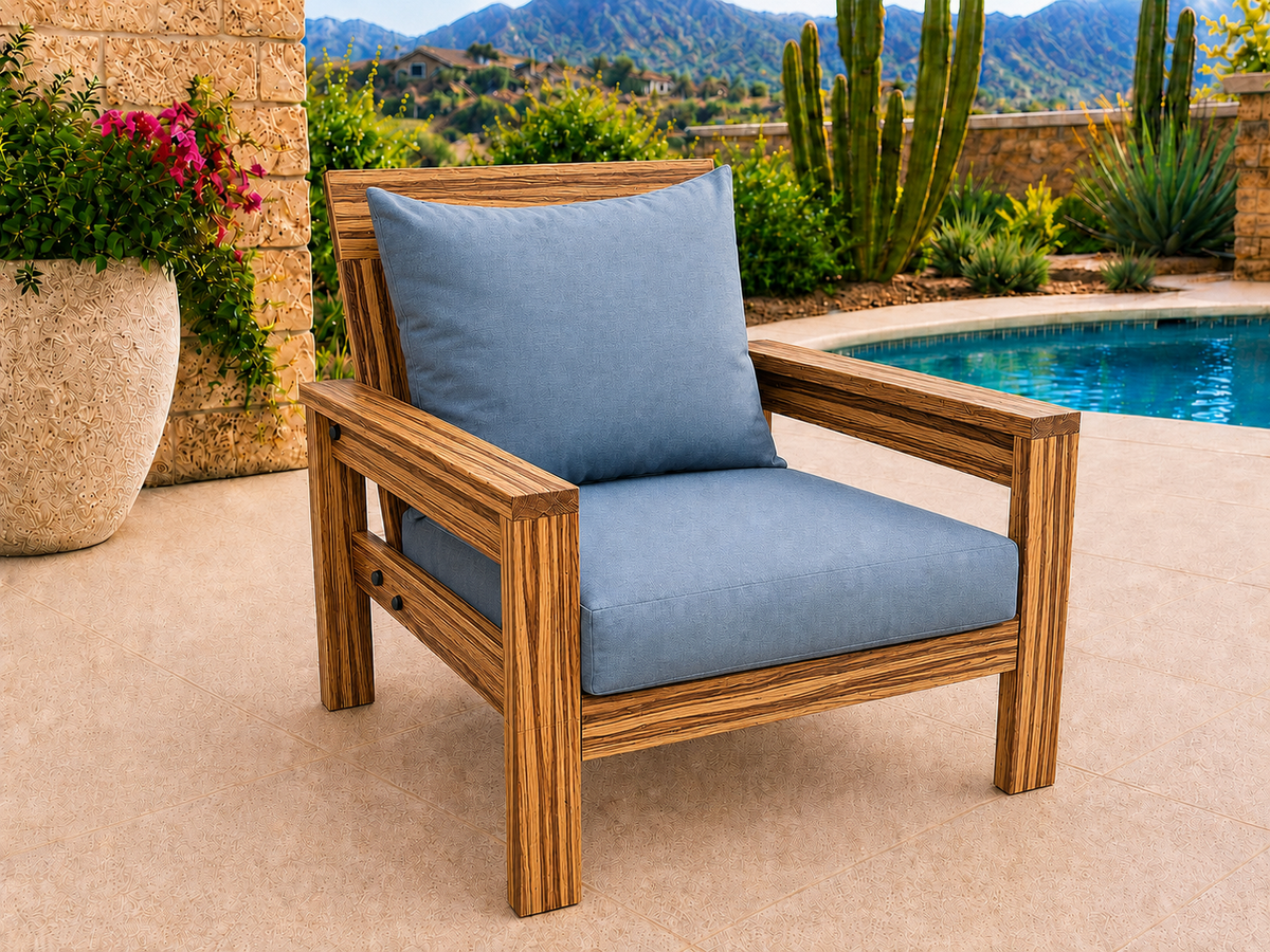 Classic Chair in Zebrawood with Satin Clear finish and blue cushions on a desert patio.