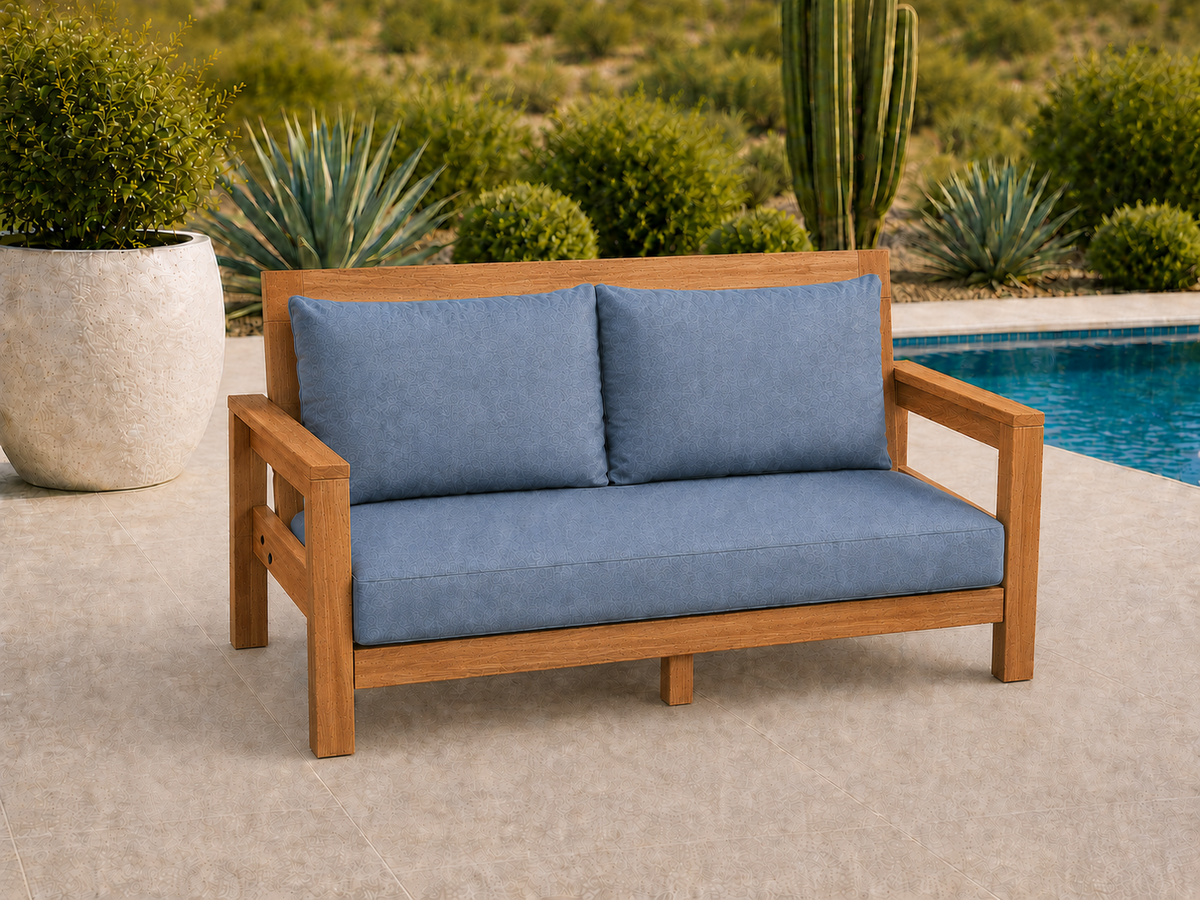 Classic Loveseat in African Mahogany with Light Honey finish and blue cushions on a desert patio.