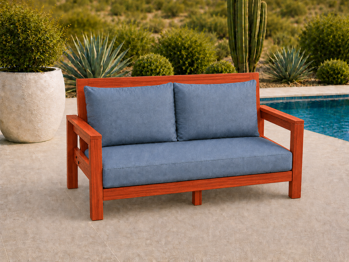 Classic Loveseat in African Padauk with Satin Clear finish and blue cushions on a desert patio.
