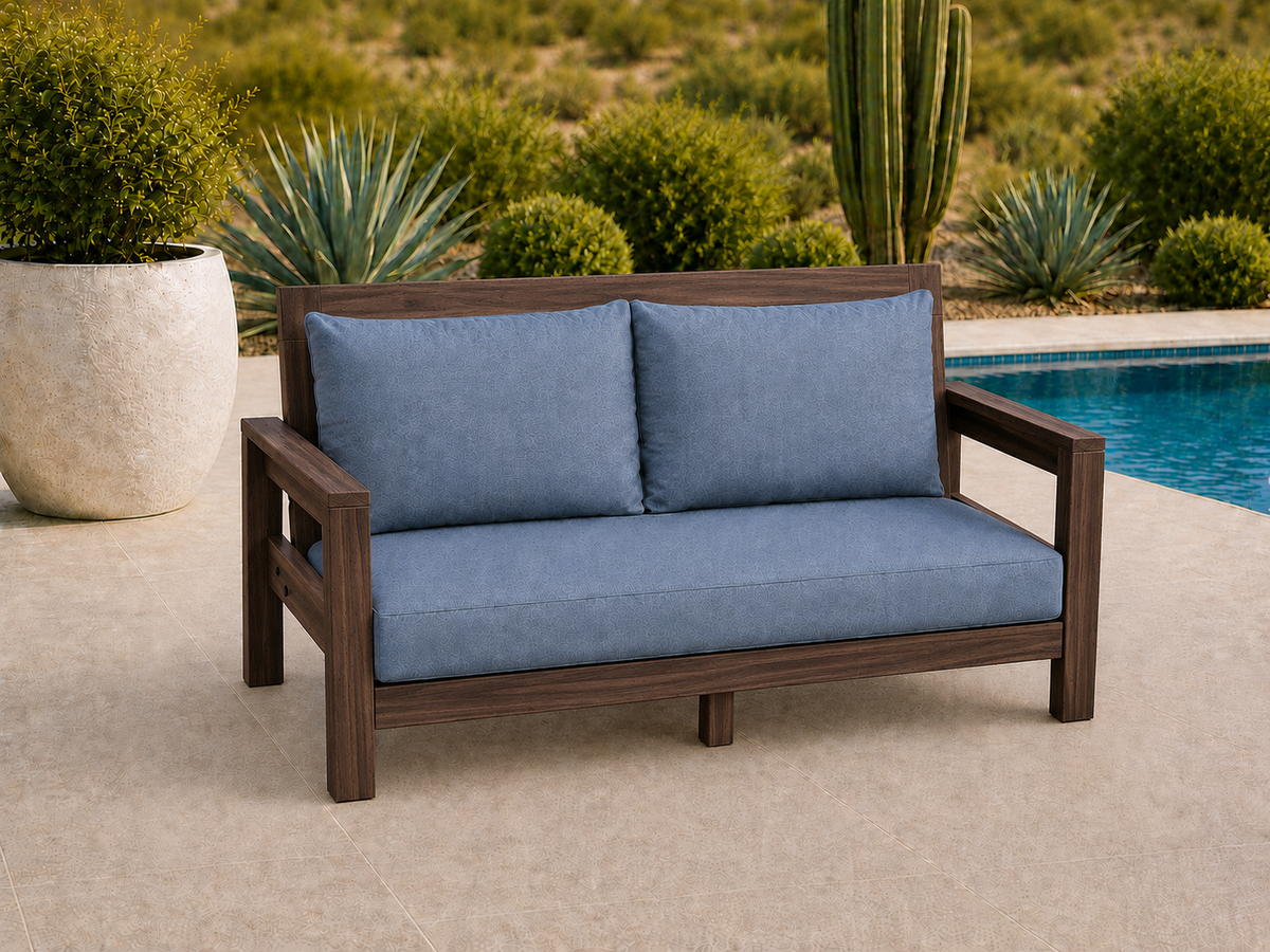 Classic Loveseat in Black Walnut with Matte Oil finish and blue cushions on a desert patio.