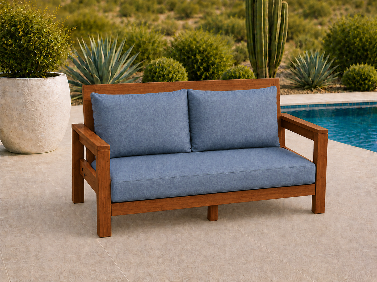 Classic Loveseat in Cherry with Satin Oil finish and blue cushions on a desert patio.