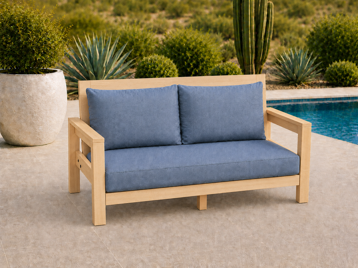 Classic Loveseat in Hard White Maple with Ultra Light Honey finish and blue cushions on a desert patio.