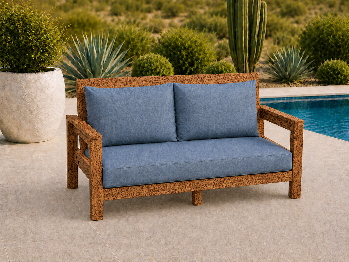 Classic Loveseat in Leopardwood with Matte Clear finish and blue cushions on a desert patio.
