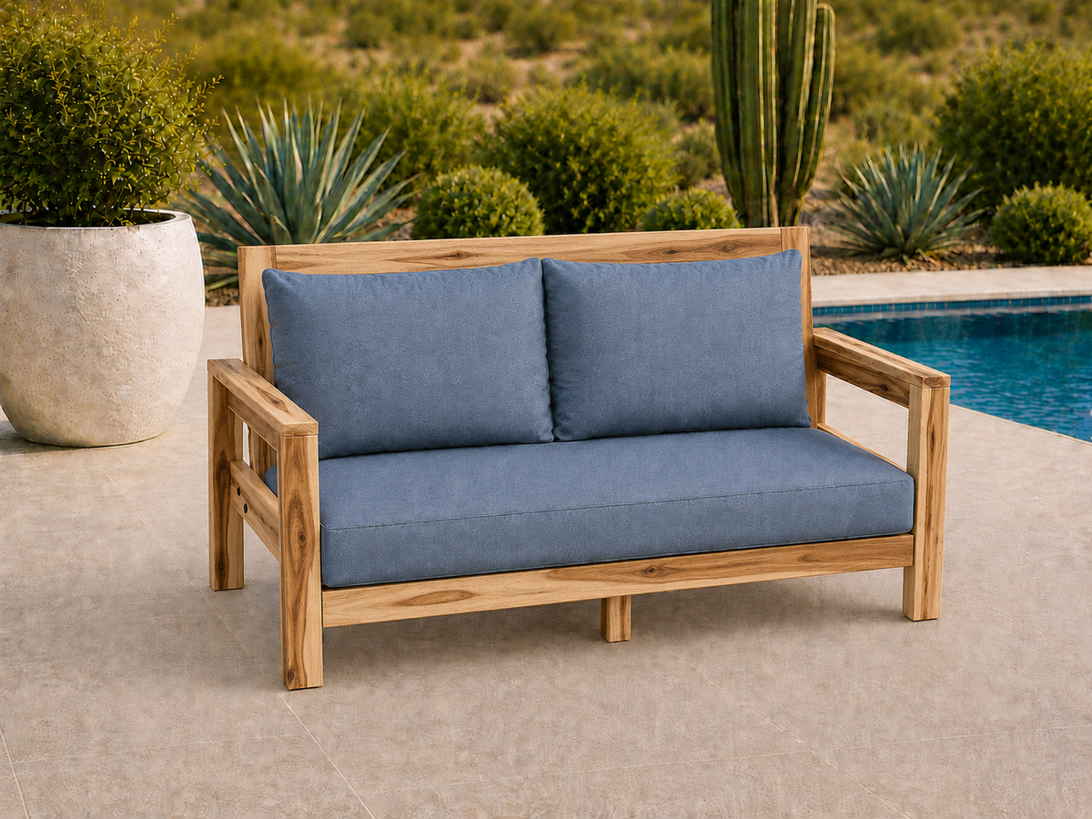 Classic Loveseat in Natural Hickory with Natural Satin finish and blue cushions on a desert patio.
