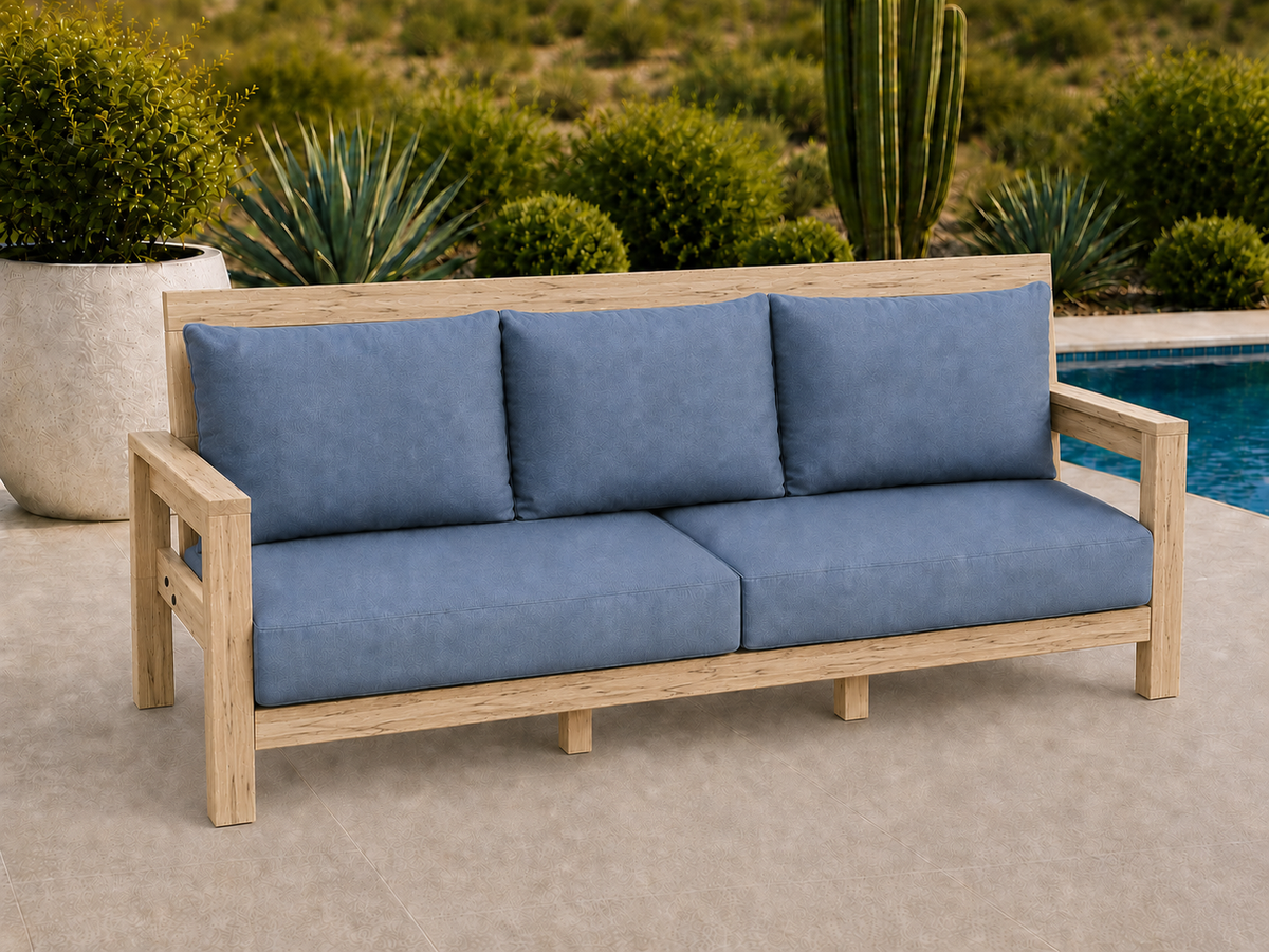 Classic Sofa in Ambrosia Maple with Natural Satin finish and blue cushions on a desert patio.