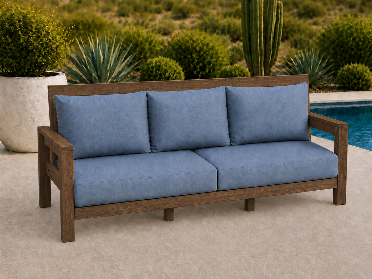 Classic Sofa in Red Oak with Walnut Reserve finish and blue cushions on a desert patio.