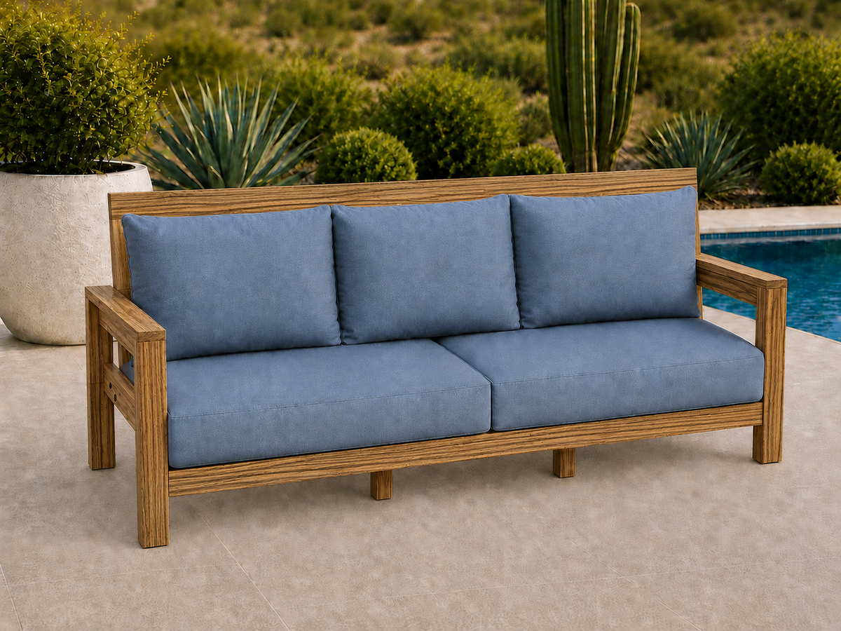 Classic Sofa in Zebrawood with Satin Clear finish and blue cushions on a desert patio.