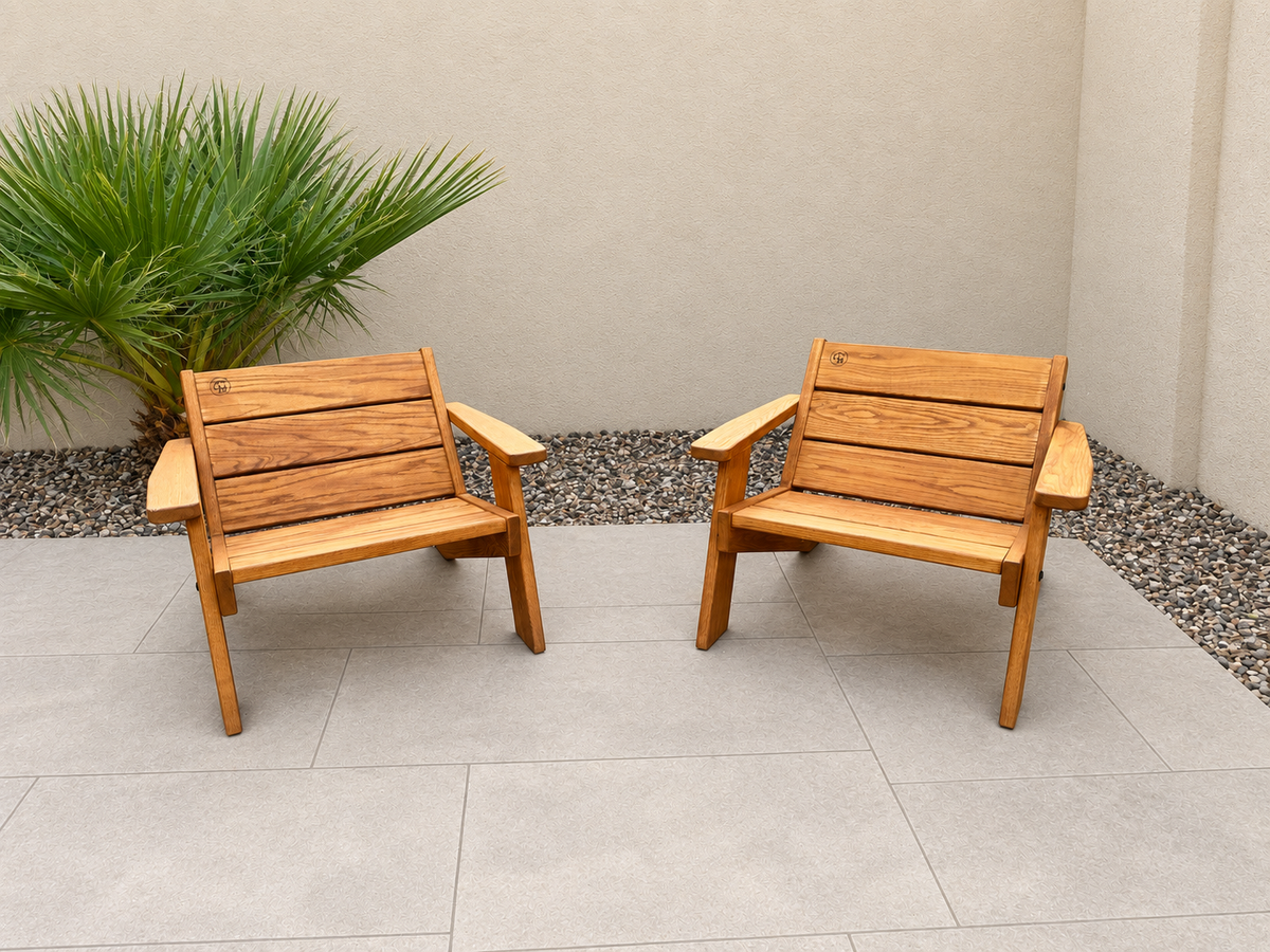 Low Boy Adirondack Chair Pair in Red Oak with Canyon Honey finish, with an edited clean patio background.