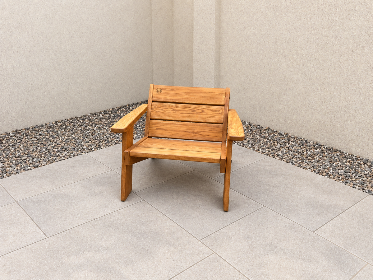 Alternate front view of the Low Boy Adirondack Chair in Red Oak with Canyon Honey finish, with an edited clean patio background.