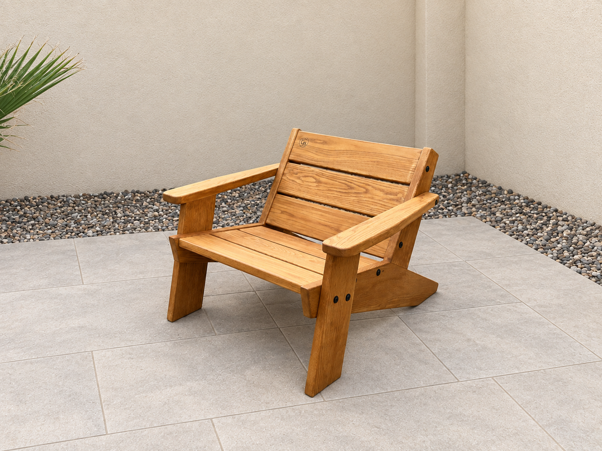 Three-quarter view of the Low Boy Adirondack Chair in Red Oak with Canyon Honey finish, with an edited clean patio background.