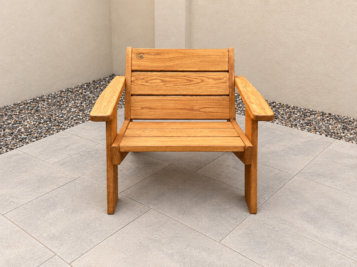 Closer front view showing the seat and back of the Low Boy Adirondack Chair in Red Oak with Canyon Honey finish, with an edited clean patio background.