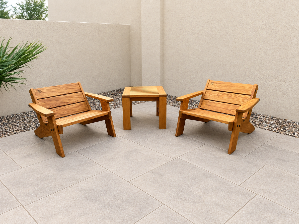 Two Low Boy Adirondack Chairs and a Classic End Table in Red Oak with Canyon Honey finish, with an edited clean patio background.
